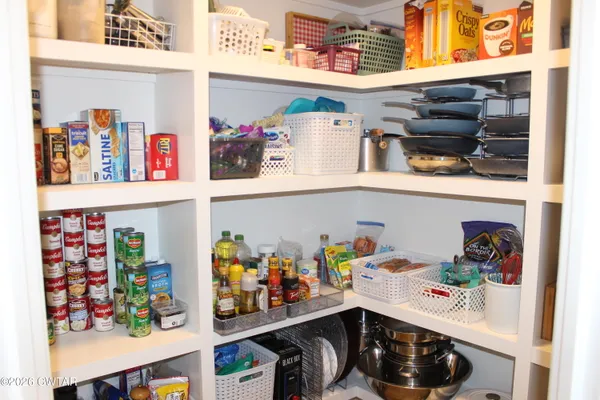 a storage room with lots of clutter and cabinets
