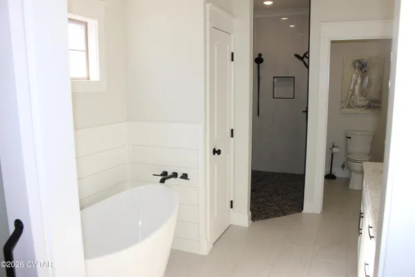 a bathroom with a bathtub and a shower