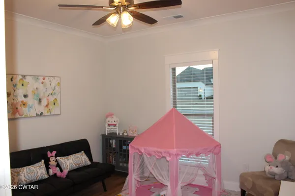 a bedroom with furniture and a window