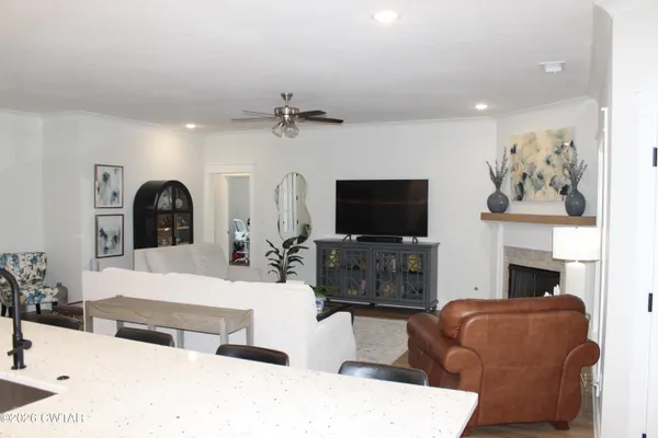 a living room with furniture a flat screen tv and a fireplace