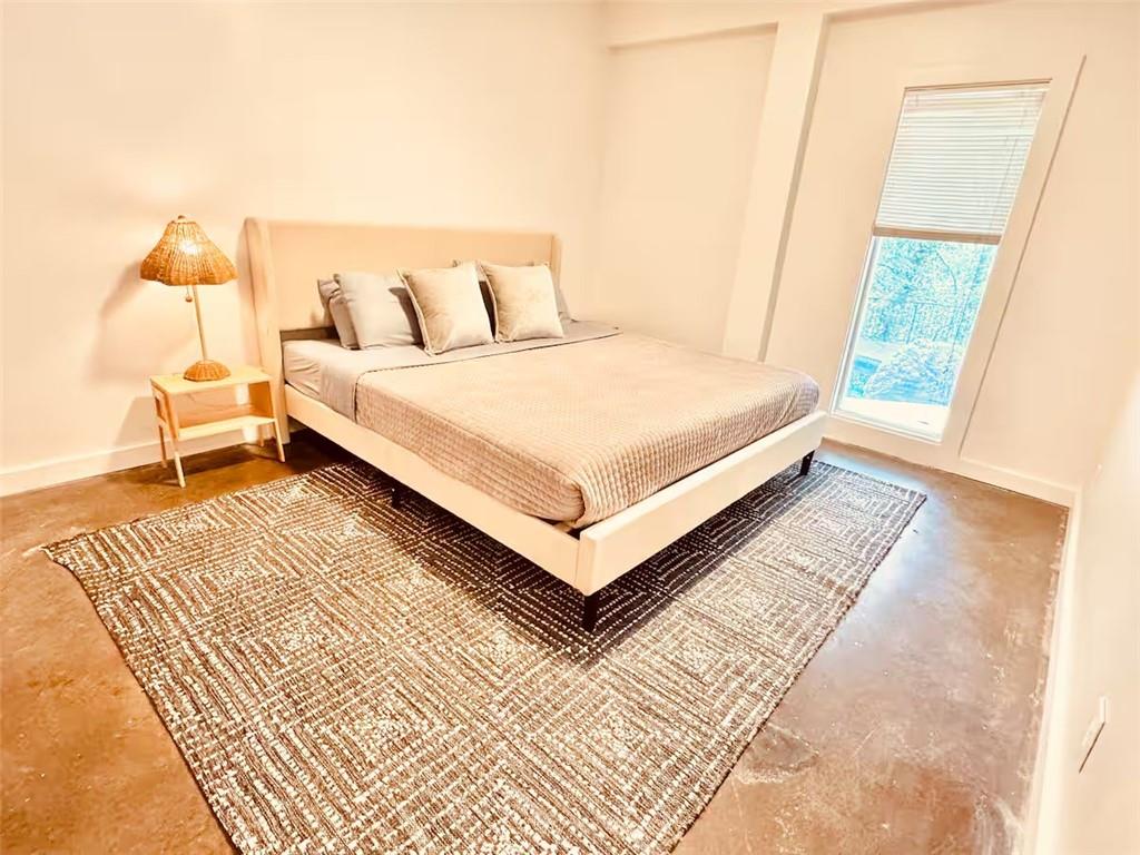 175 River Ct Parkway Atlanta, GA 30328 - Photo 31 of 50 a bed sitting in a bedroom next to a window