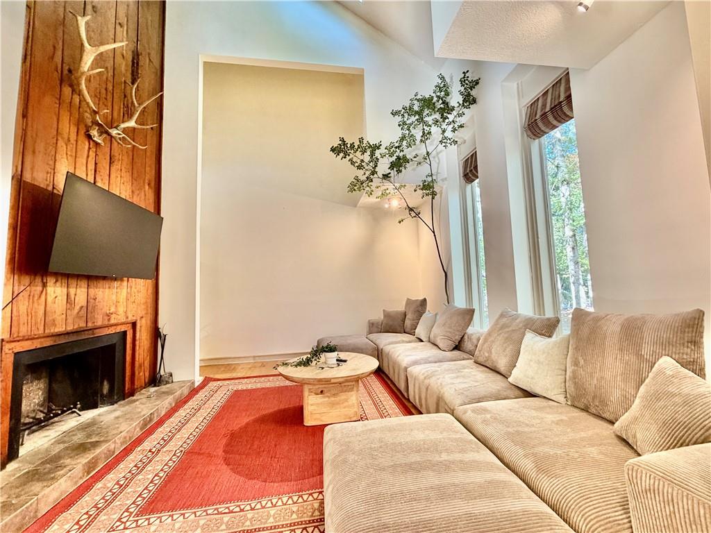 175 River Ct Parkway Atlanta, GA 30328 - Photo 10 of 50 a living room with furniture and a fireplace