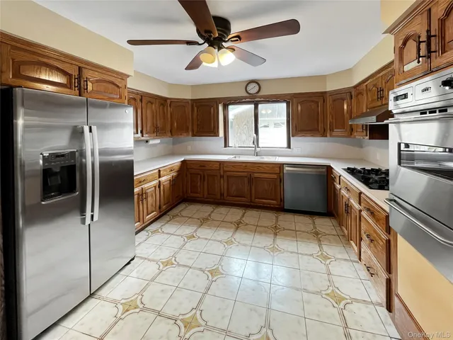 a large kitchen with cabinets and stainless steel appliances