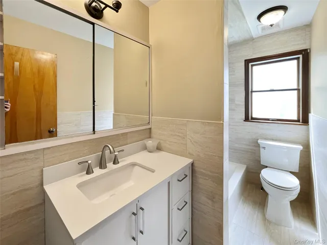 a bathroom with a sink toilet and mirror