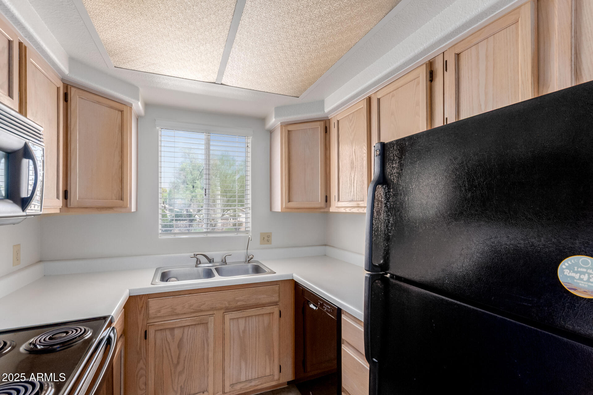 1825 West Ray Road, Unit 2070 Chandler, AZ 85224 - Photo 11 of 51 a kitchen with a sink a refrigerator and window