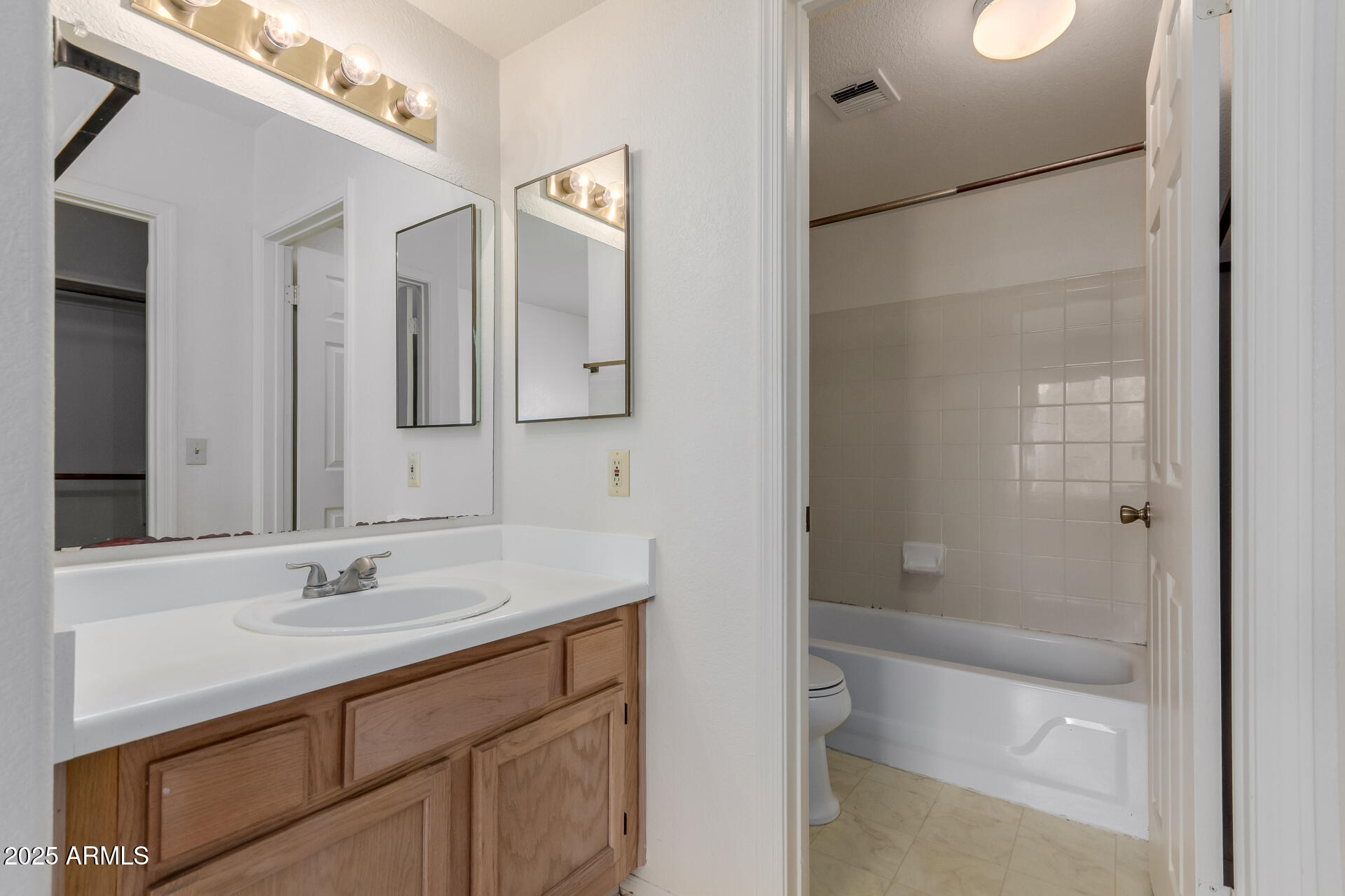 1825 West Ray Road, Unit 2070 Chandler, AZ 85224 - Photo 18 of 51 a bathroom with a shower sink vanity and mirror