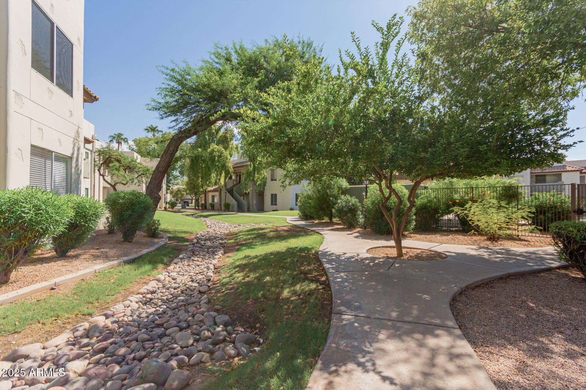 1825 West Ray Road, Unit 2070 Chandler, AZ 85224 - Photo 27 of 51 a view of a street with a yard and plants