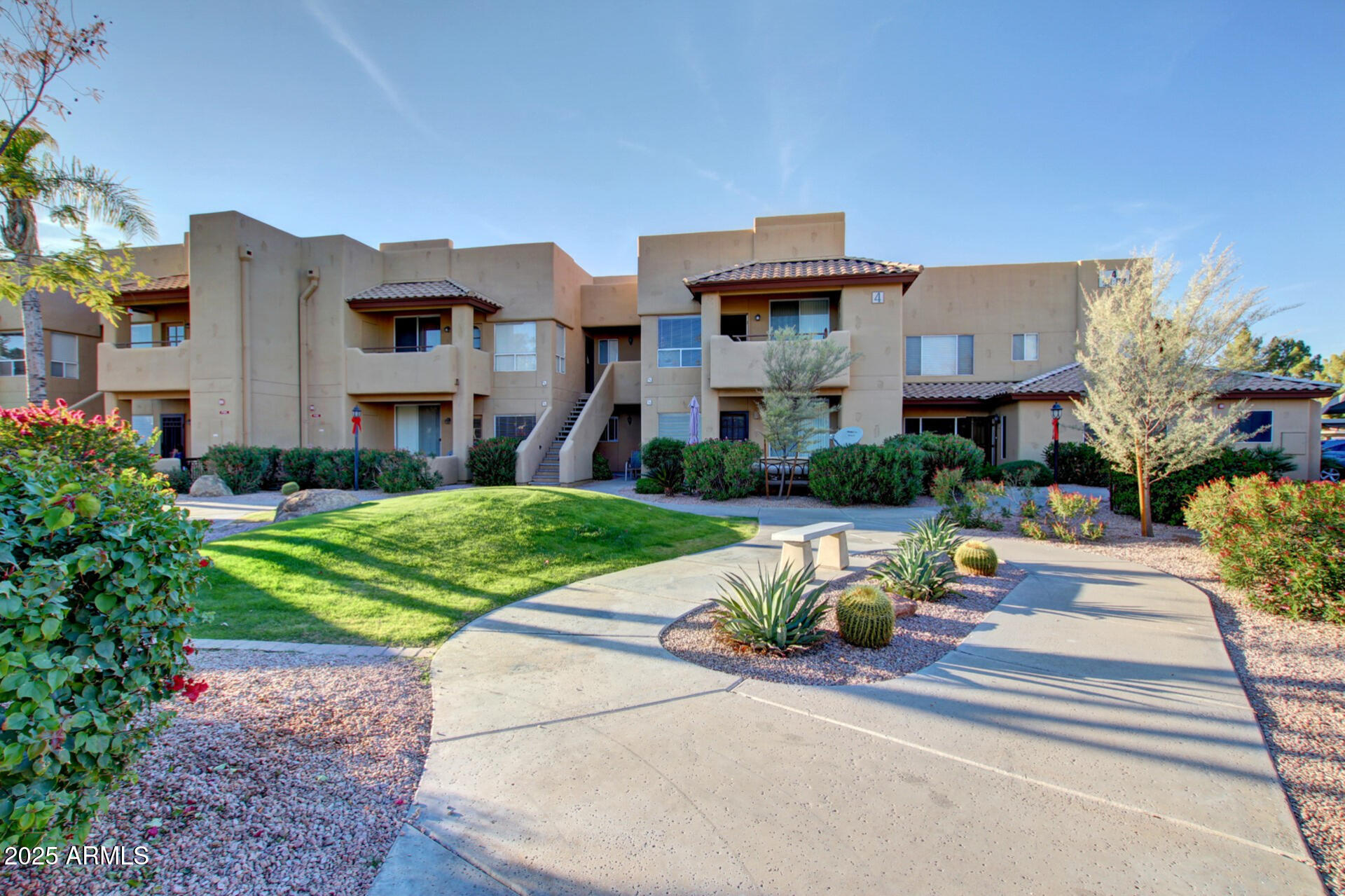 1825 West Ray Road, Unit 2070 Chandler, AZ 85224 - Photo 31 of 51 a front view of a house with a yard fire pit and outdoor seating