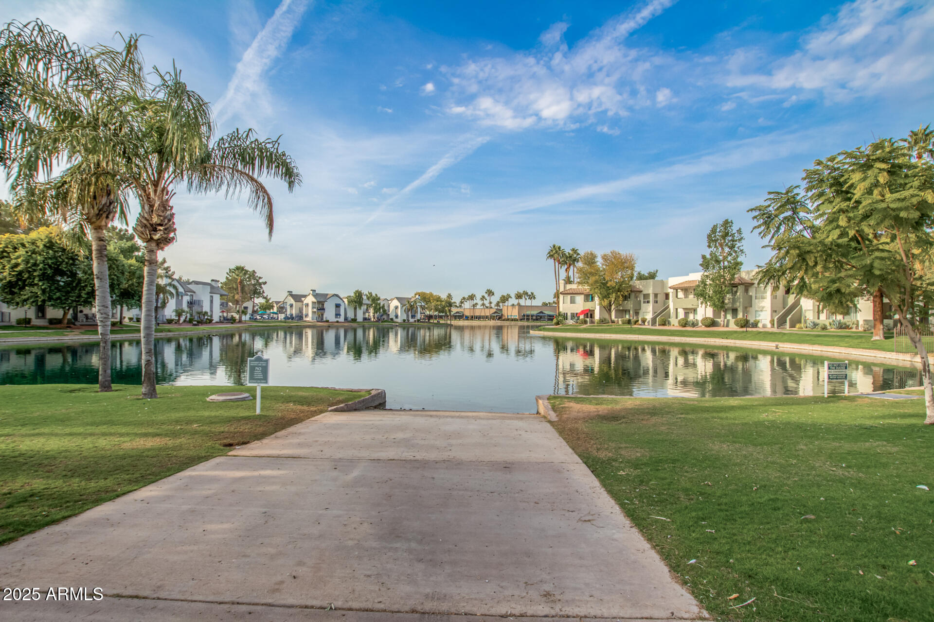 1825 West Ray Road, Unit 2070 Chandler, AZ 85224 - Photo 38 of 51 a view of a lake with a yard and large trees