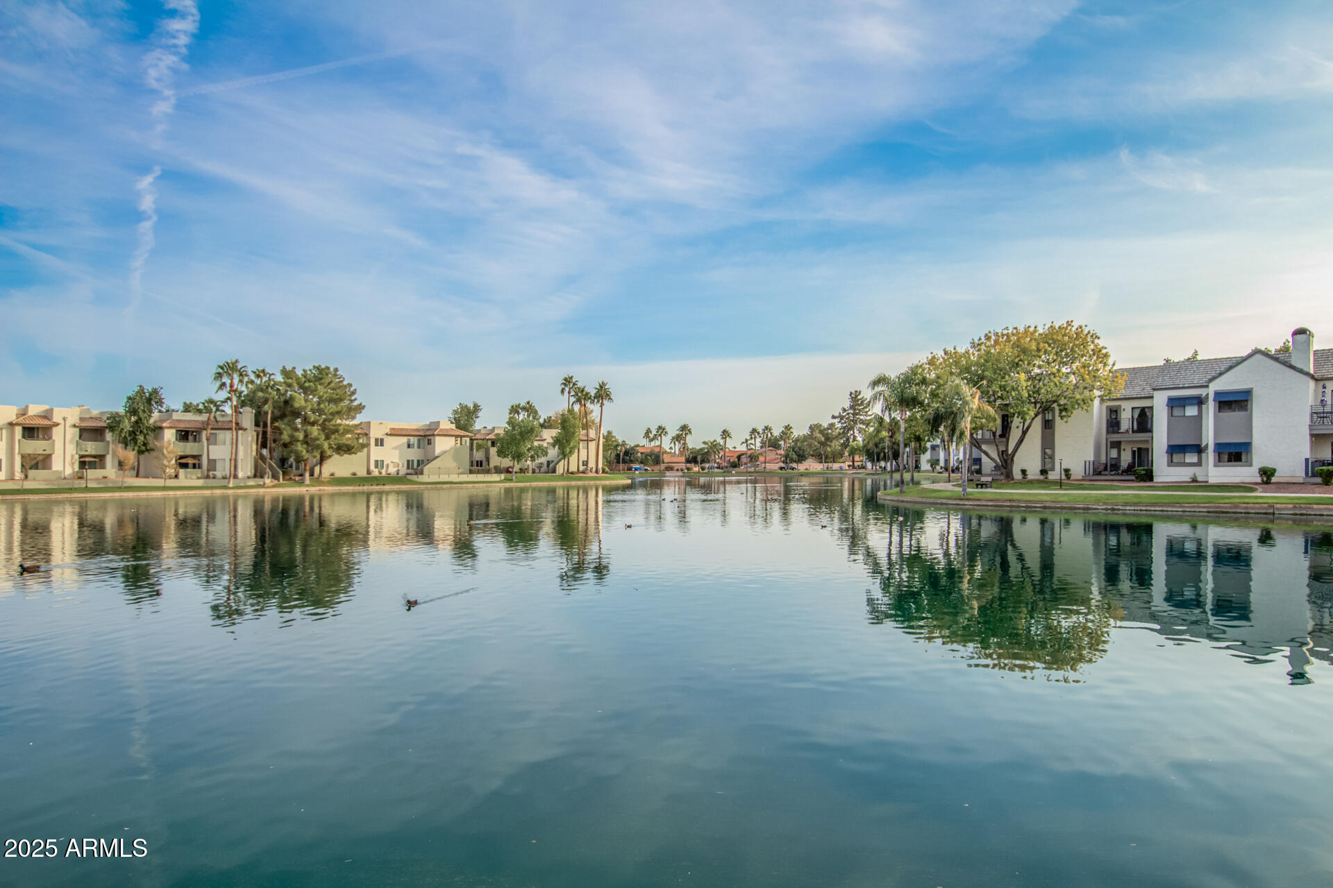 1825 West Ray Road, Unit 2070 Chandler, AZ 85224 - Photo 43 of 51 a view of a lake with houses in front of it