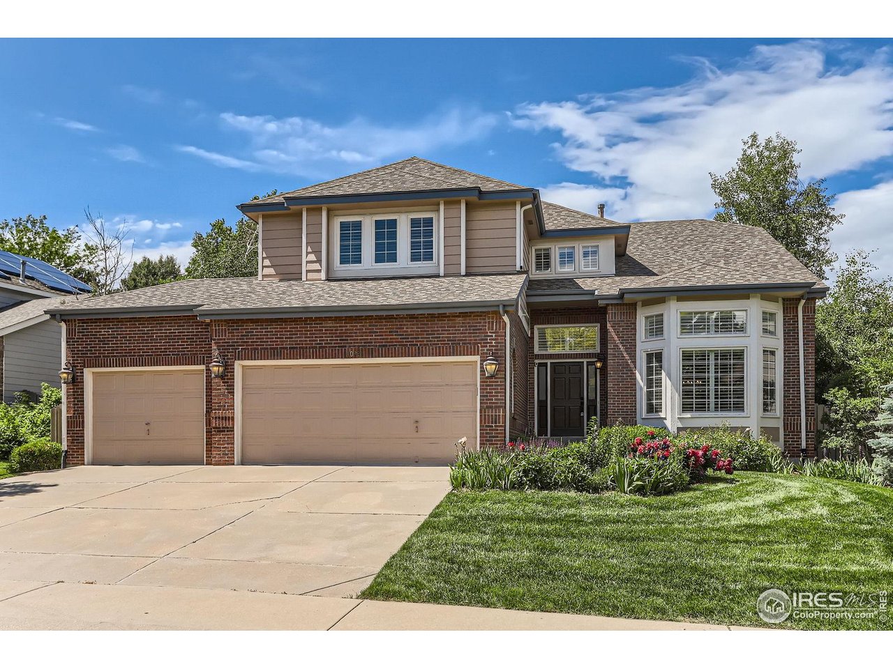 1069 Monarch Way Superior, CO 80027 - Photo 1 of 40 a front view of a house with a garden