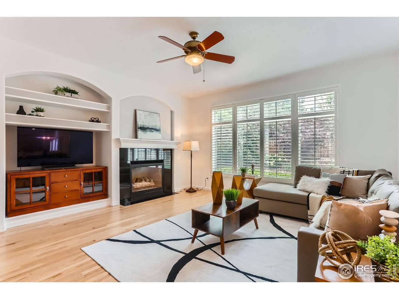 1069 Monarch Way Superior, CO 80027 - Photo 12 of 40 a living room with furniture and a flat screen tv with kitchen view