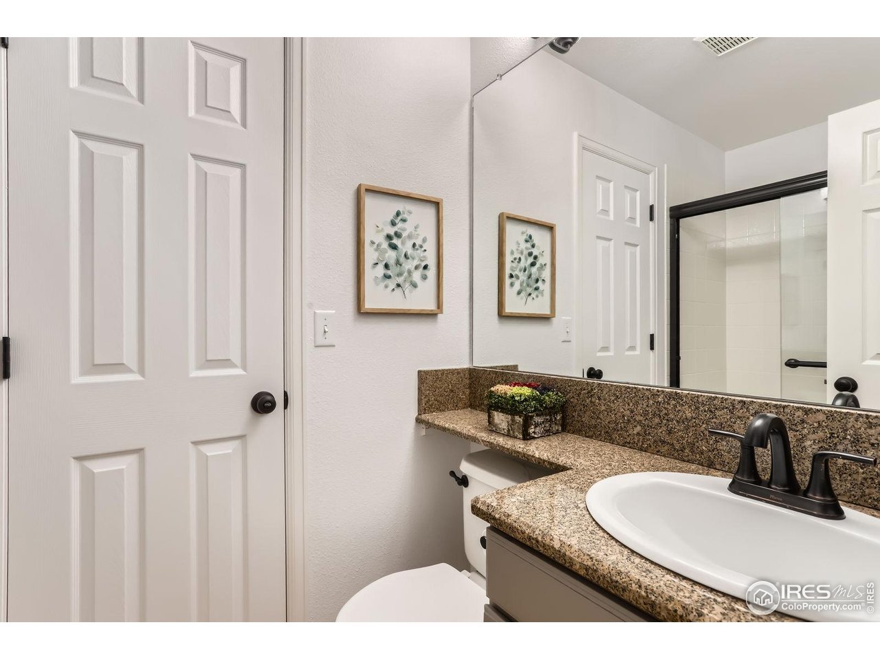 1069 Monarch Way Superior, CO 80027 - Photo 15 of 40 a bathroom with a granite countertop toilet a sink and mirror
