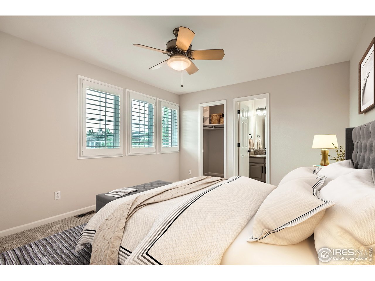 1069 Monarch Way Superior, CO 80027 - Photo 21 of 40 a bedroom with a bed and a chandelier