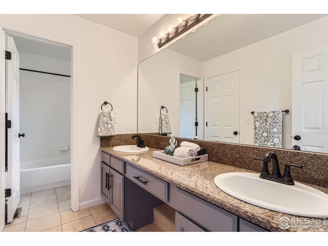 1069 Monarch Way Superior, CO 80027 - Photo 26 of 40 a bathroom with a granite countertop sink mirror and a