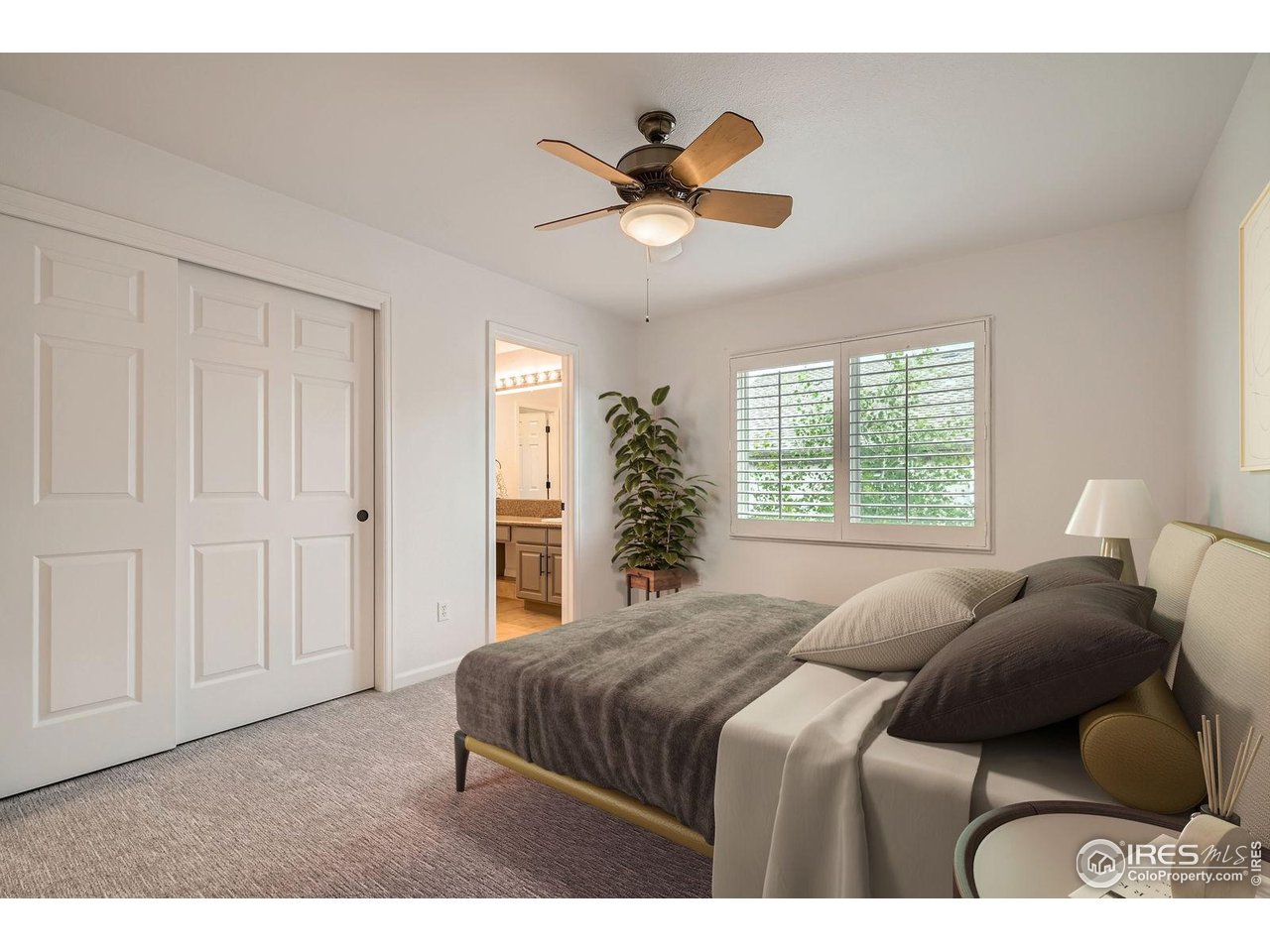 1069 Monarch Way Superior, CO 80027 - Photo 27 of 40 a bedroom with a bed and a chandelier