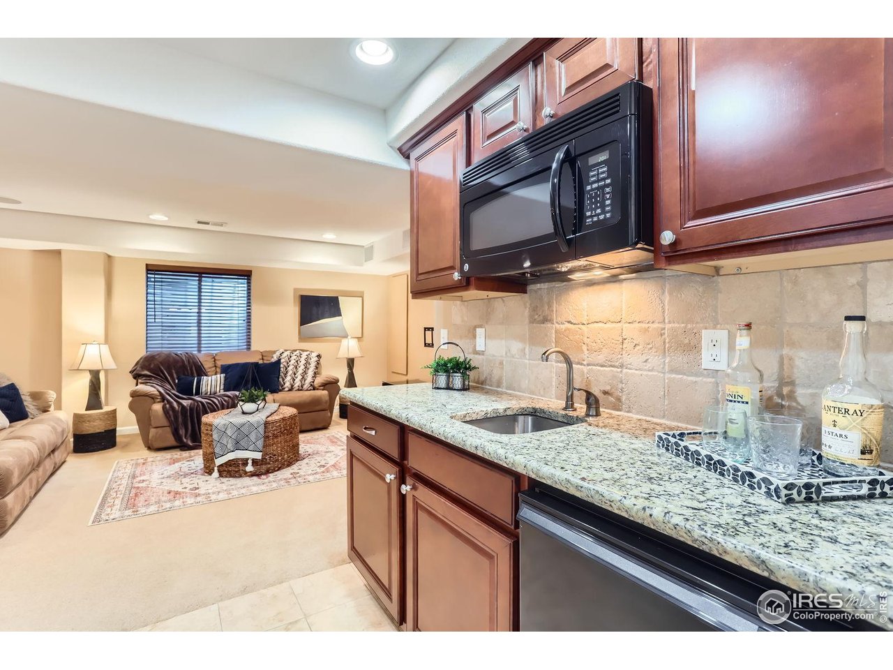 1069 Monarch Way Superior, CO 80027 - Photo 29 of 40 a living room with granite countertop stainless steel appliances kitchen island granite countertop a sink dishwasher stove and microwave
