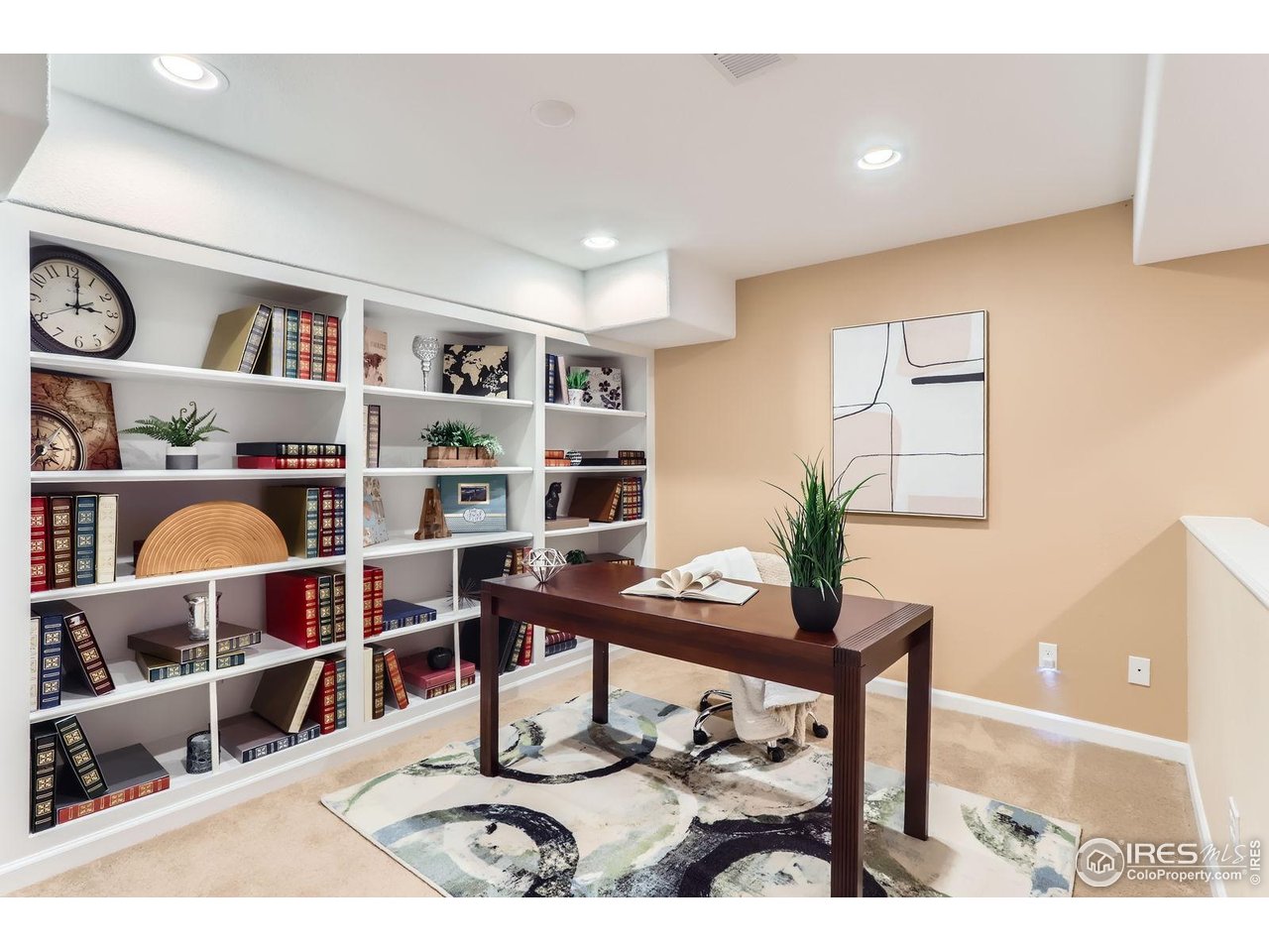 1069 Monarch Way Superior, CO 80027 - Photo 34 of 40 a living room with lots of furniture and a book shelf