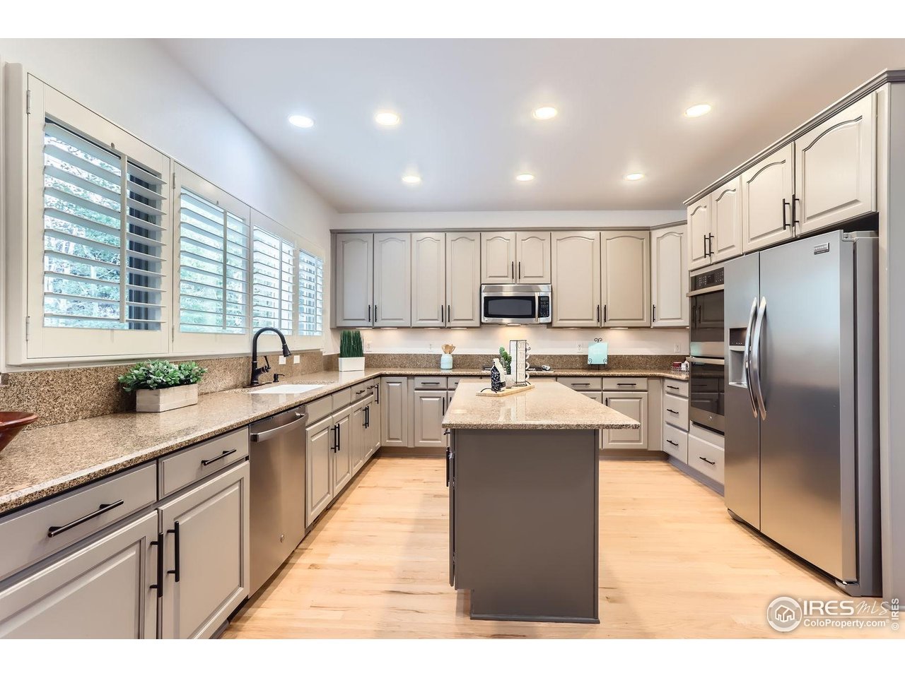 1069 Monarch Way Superior, CO 80027 - Photo 9 of 40 a kitchen with stainless steel appliances granite countertop a sink a stove a refrigerator a center island and cabinets