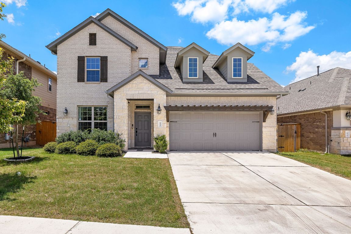 a front view of a house with garden
