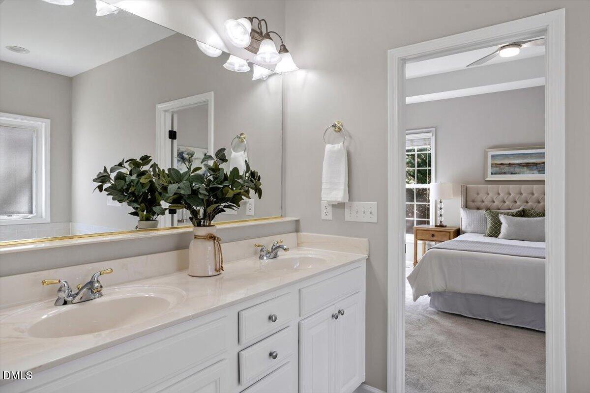 327 Whitney Lane Durham, NC 27713 - Photo 17 of 33 a bathroom with a double vanity sink and a mirror