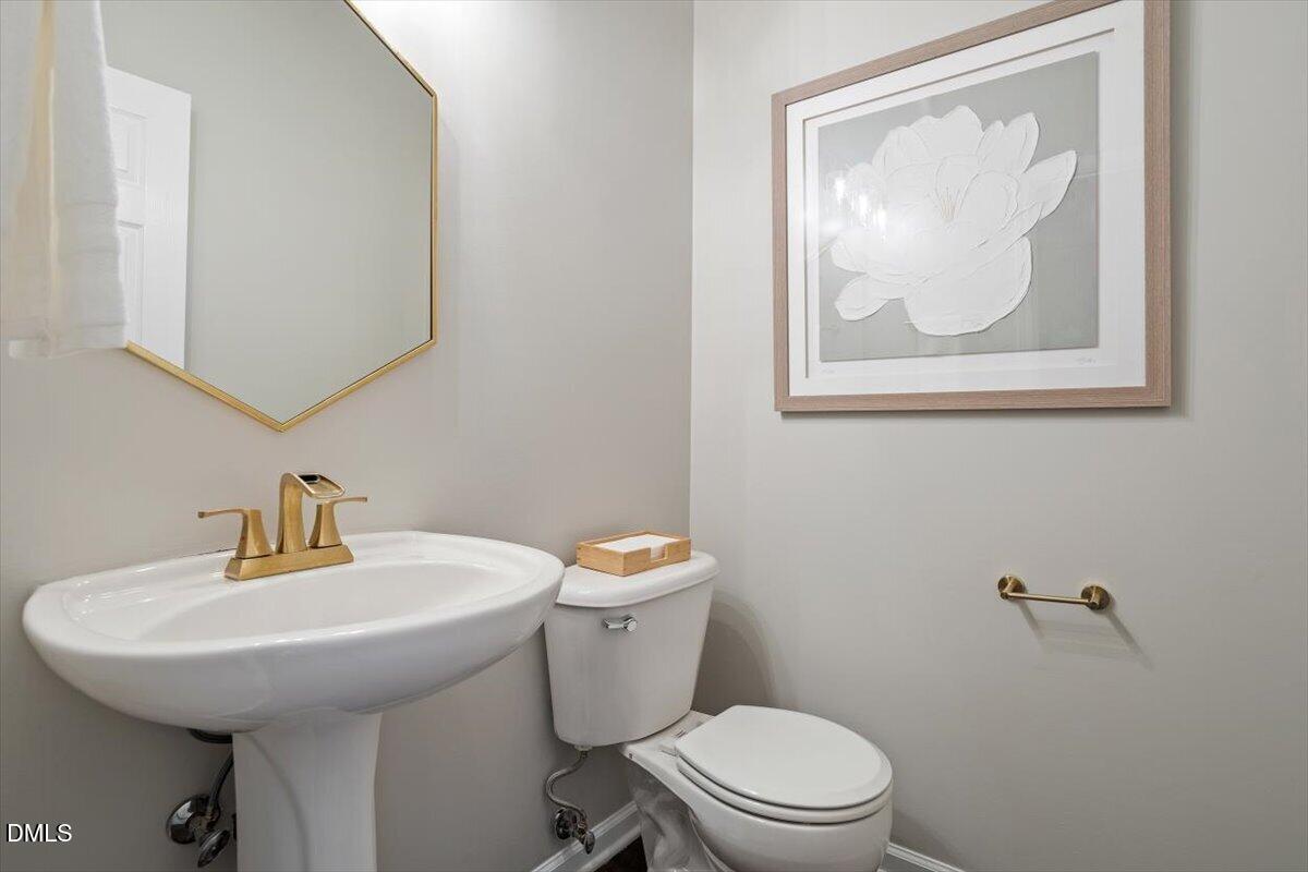 327 Whitney Lane Durham, NC 27713 - Photo 20 of 33 a bathroom with a toilet a sink and mirror