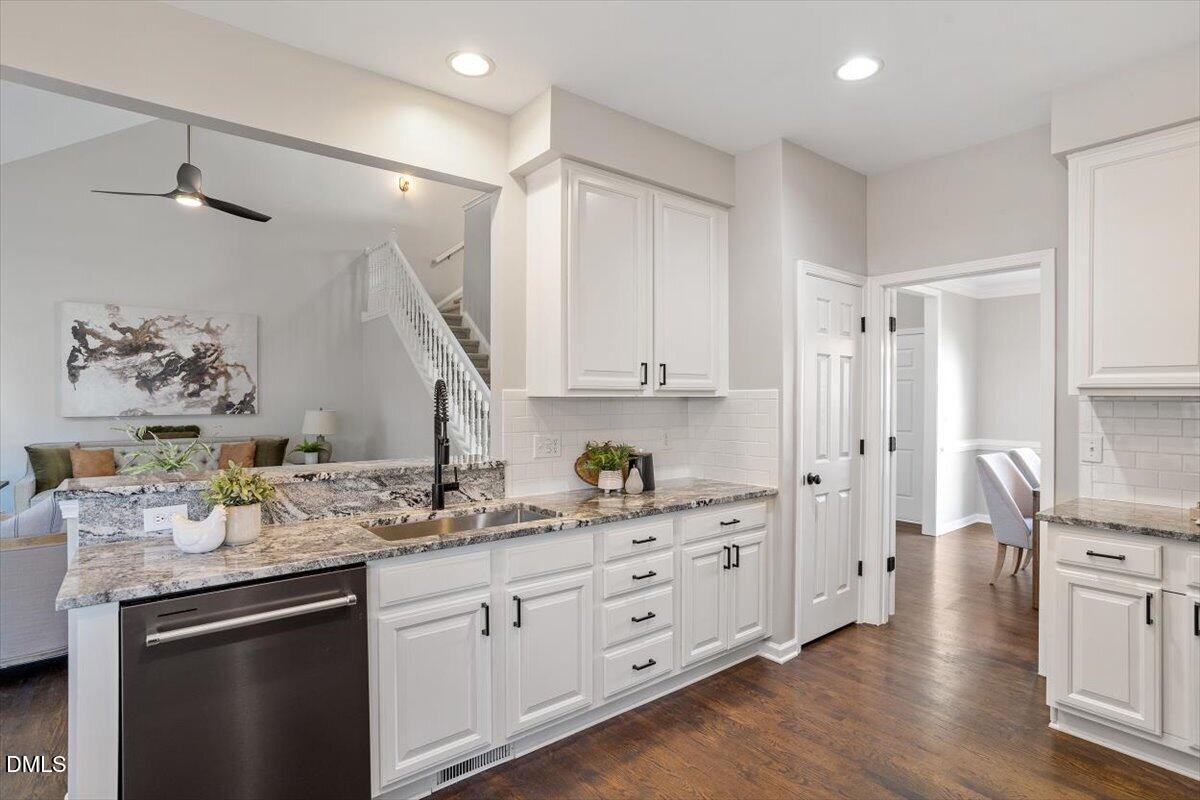 327 Whitney Lane Durham, NC 27713 - Photo 5 of 33 a kitchen with stainless steel appliances sink stove and wooden floor
