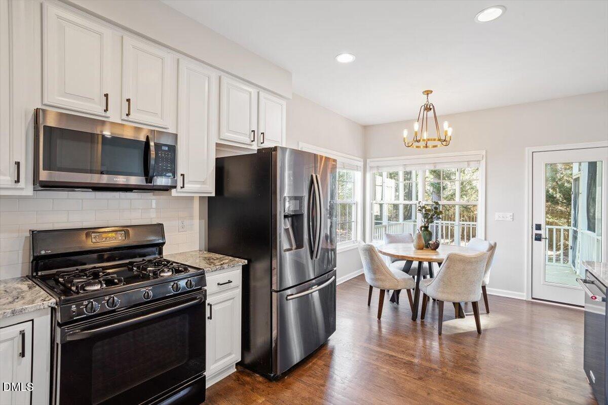 327 Whitney Lane Durham, NC 27713 - Photo 6 of 33 a kitchen with stainless steel appliances a stove a microwave and a refrigerator