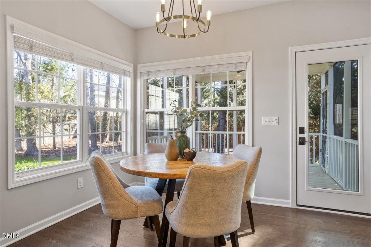 327 Whitney Lane Durham, NC 27713 - Photo 9 of 33 a dining room with furniture a chandelier and wooden floor