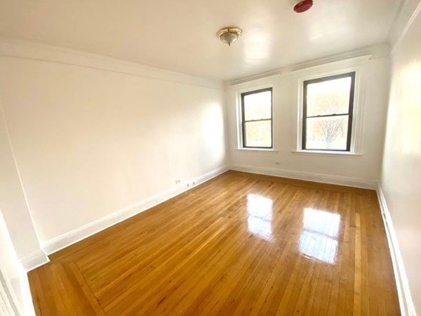466 Commonwealth Avenue, Unit 302 Boston, MA 02215 - Photo 7 of 12 a view of empty room with wooden floor and fan