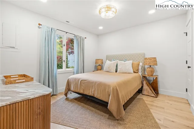 a bedroom with a bed and window