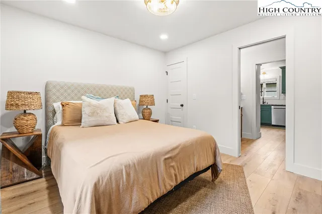 a bedroom with a bed and a chandelier