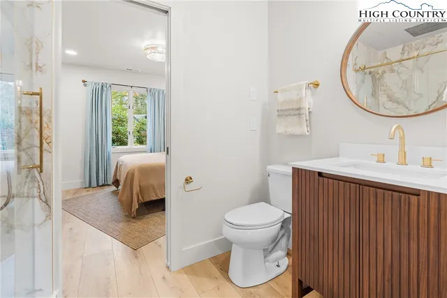 a bathroom with a toilet sink and mirror