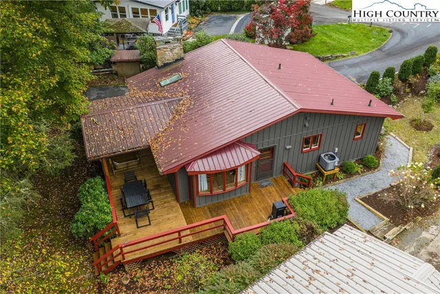 an aerial view of a house with garden space and street view