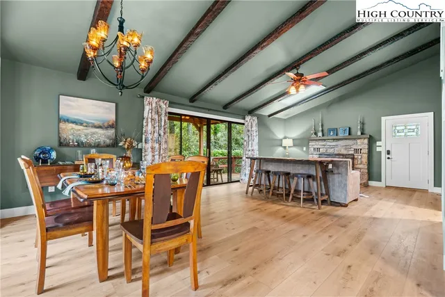 a dining room with furniture garden view and a chandelier