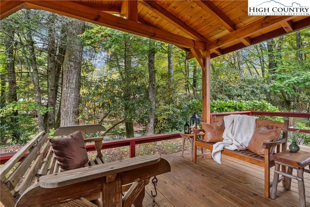 a roof deck with table and chairs and wooden floor