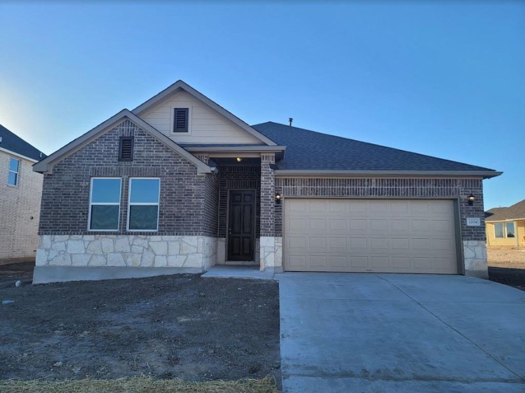 1004 Dog Iron Street Georgetown, TX 78633 - Photo 1 of 1 a front view of a house with a yard and garage