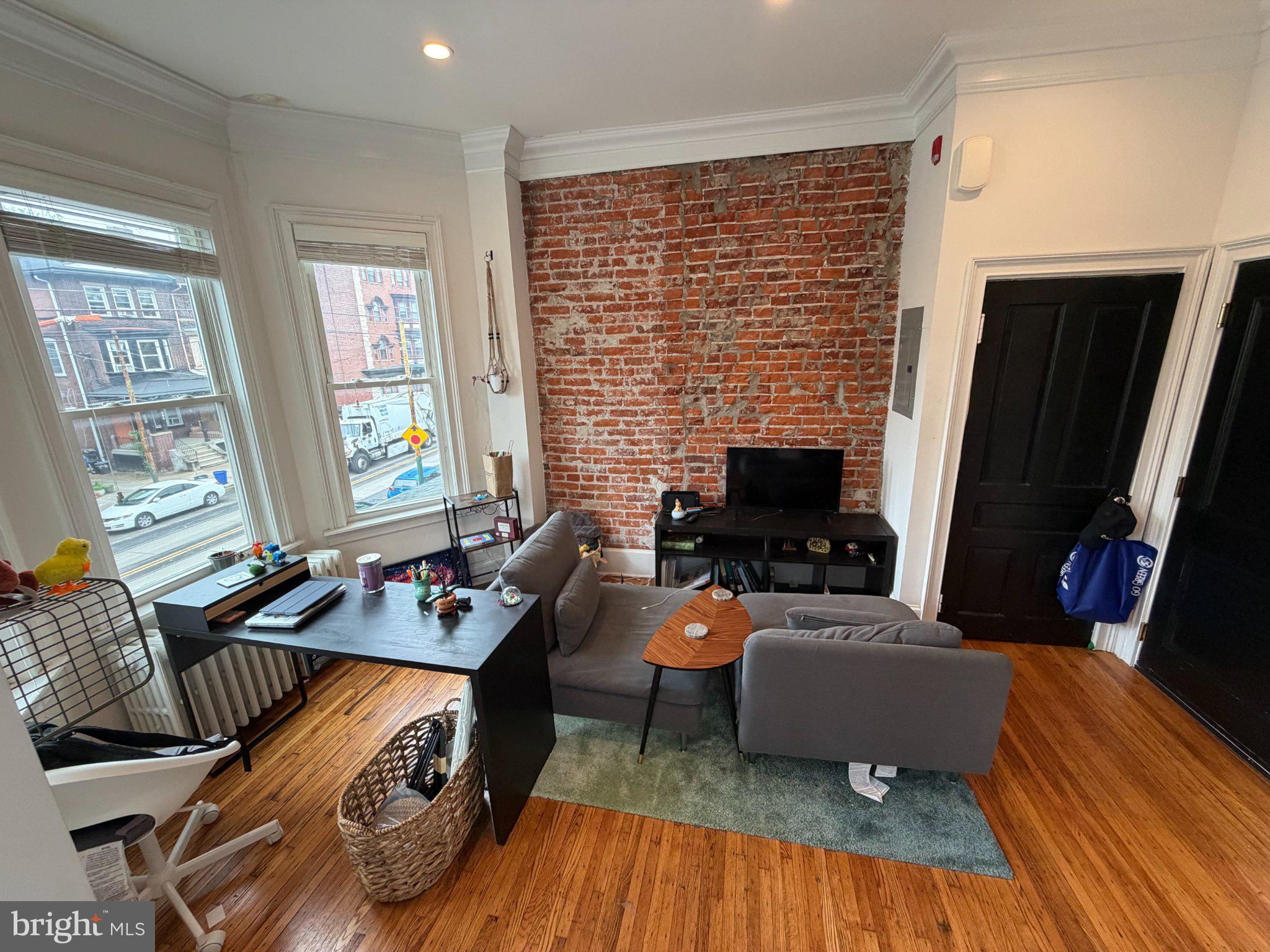 815 South 49th Street Philadelphia, PA 19143 - Photo 19 of 72 a living room with furniture and a fireplace