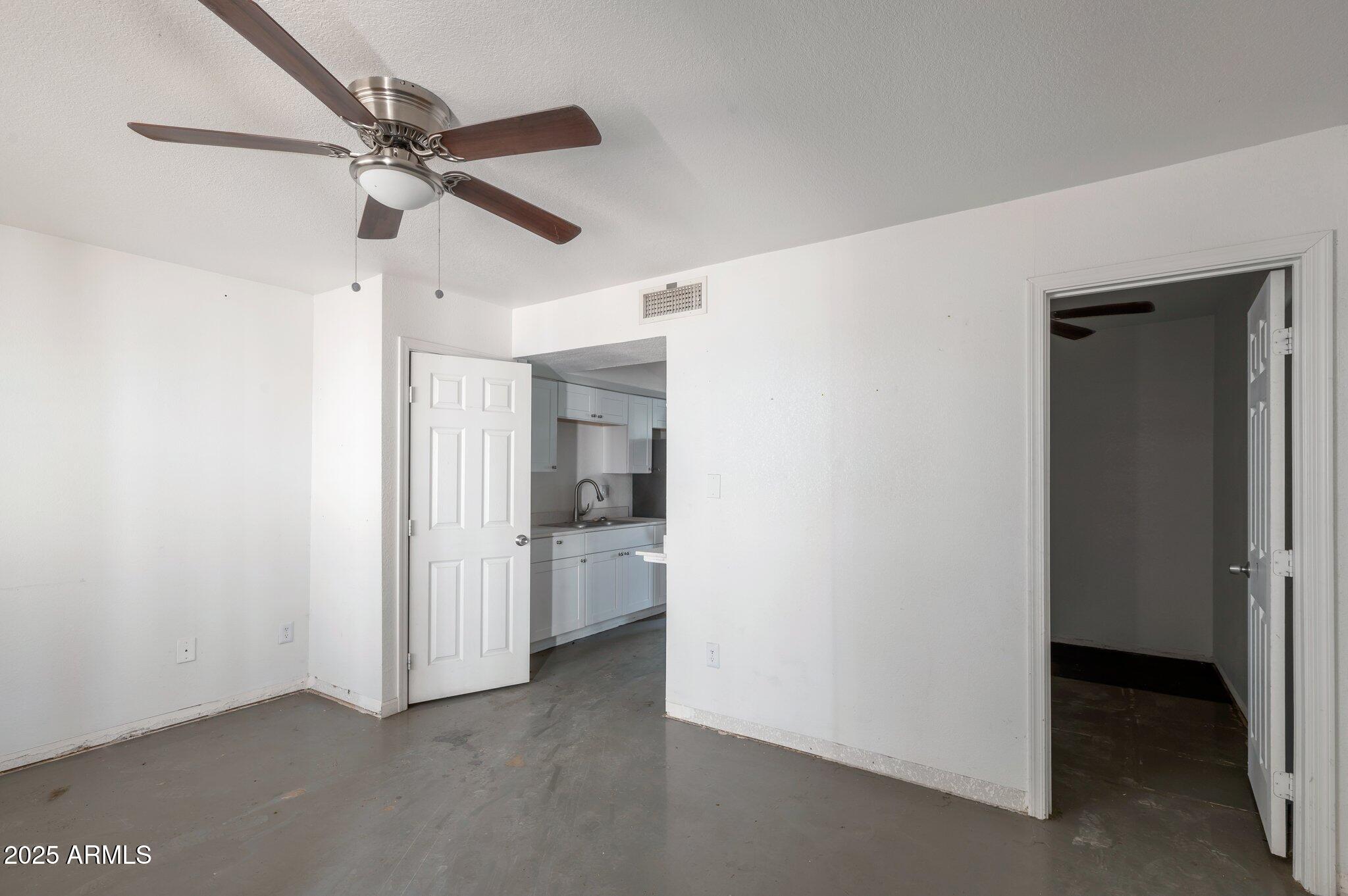 18202 Cave Creek Road, Unit 129 Phoenix, AZ 85032 - Photo 2 of 9 a view of a room with a ceiling fan and refrigerator