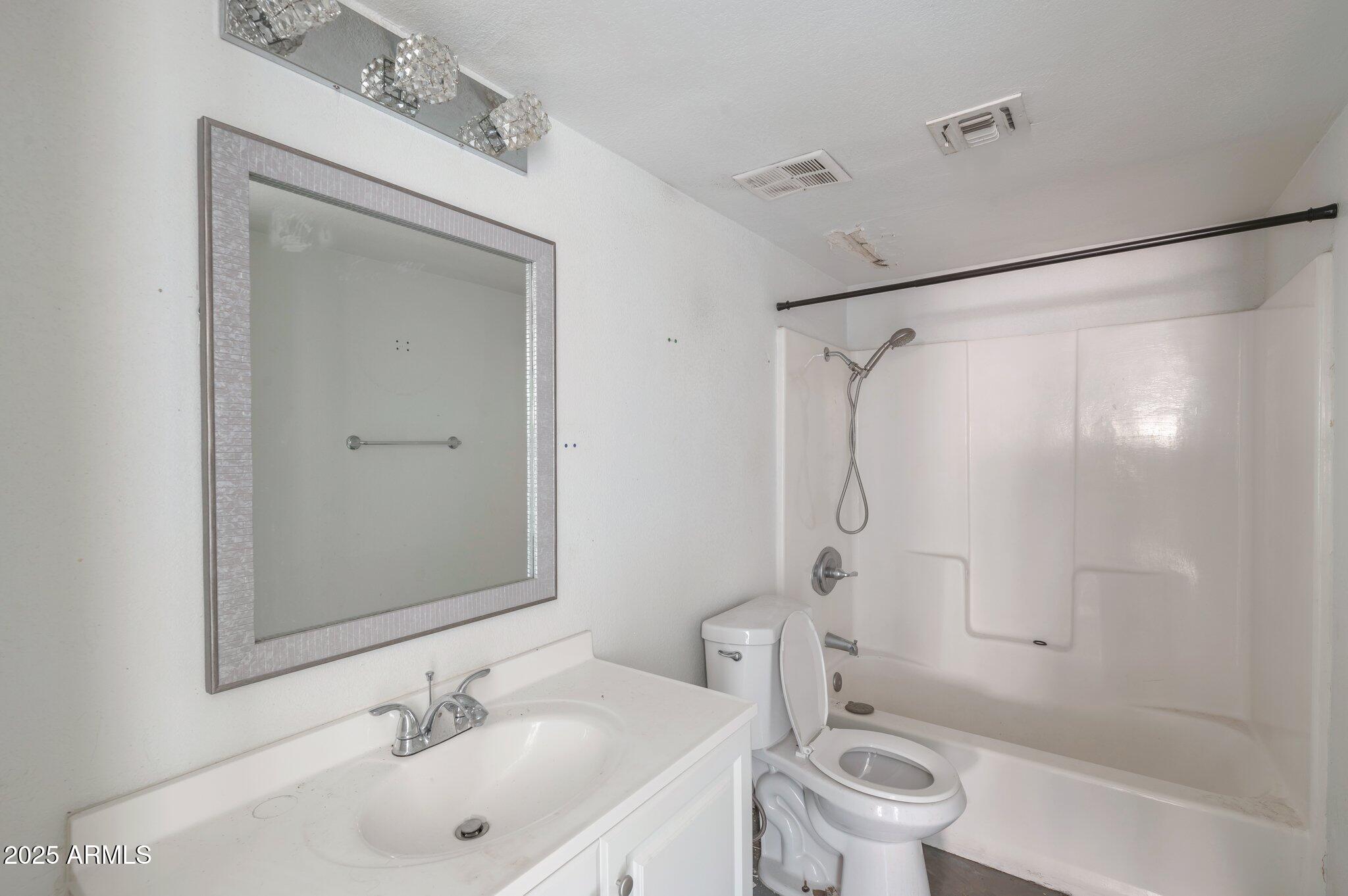18202 Cave Creek Road, Unit 129 Phoenix, AZ 85032 - Photo 4 of 9 a bathroom with a sink toilet and shower