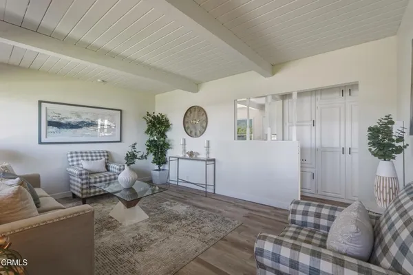 a living room with furniture and a clock