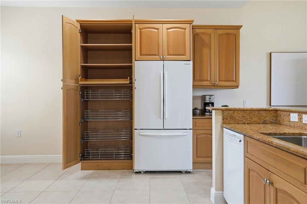 9263 Museo Circle, Unit 103 Naples, FL 34114 - Photo 11 of 49 Kitchen with white appliances, light stone countertops, and light tile patterned floors
