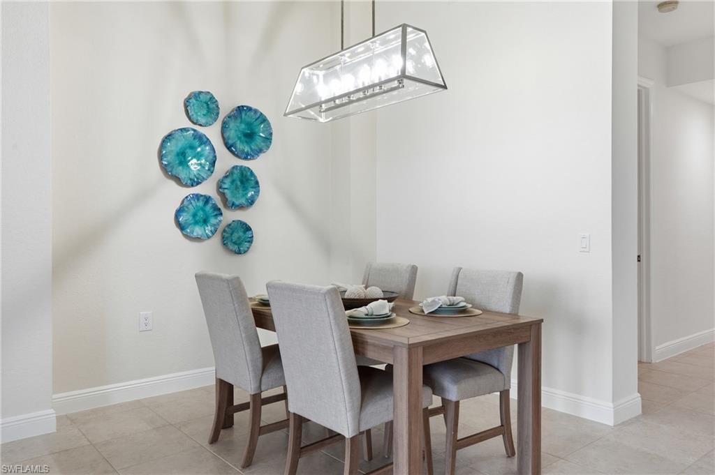 9263 Museo Circle, Unit 103 Naples, FL 34114 - Photo 12 of 49 Dining space with light tile patterned floors