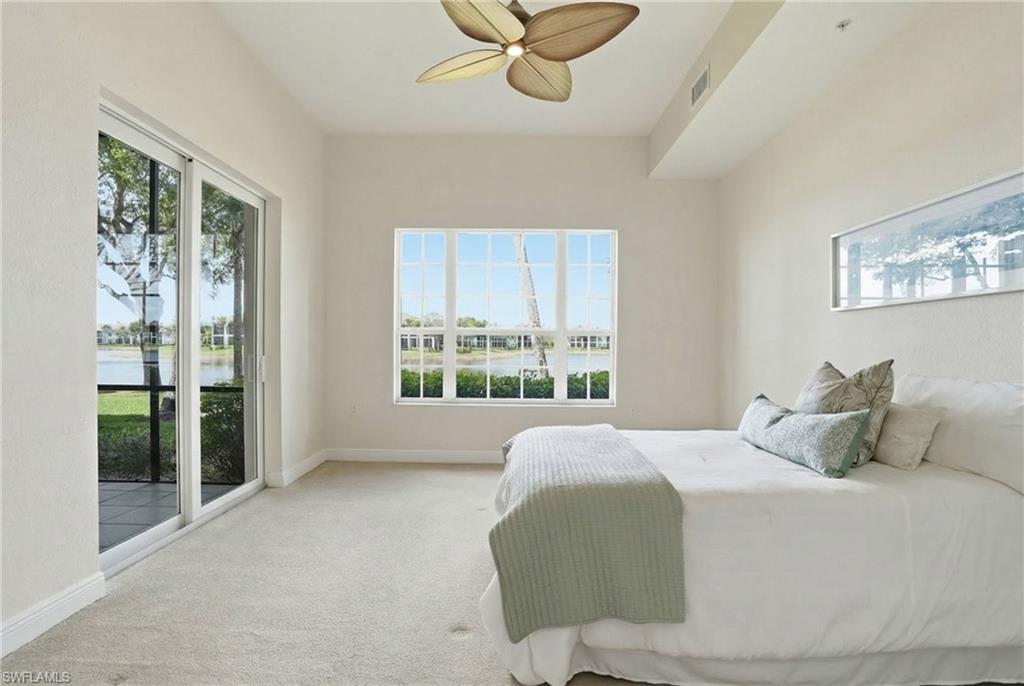9263 Museo Circle, Unit 103 Naples, FL 34114 - Photo 17 of 49 Primary Bedroom with access to outside flooring, a ceiling fan, and a water view