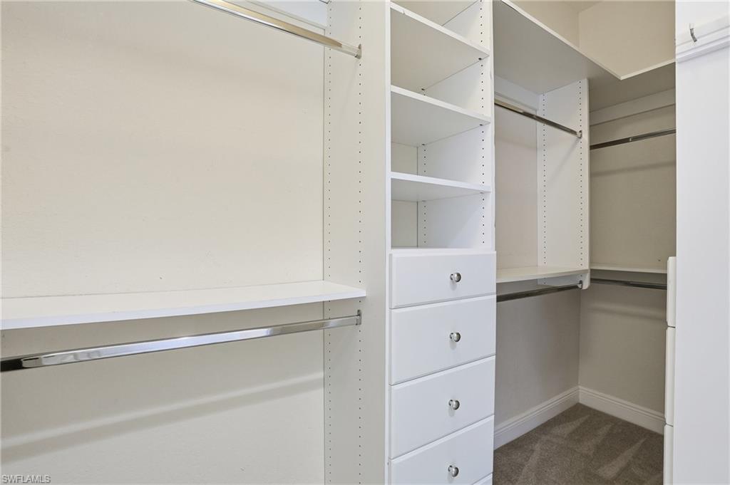 9263 Museo Circle, Unit 103 Naples, FL 34114 - Photo 21 of 49 Walk in closet featuring dark colored carpet