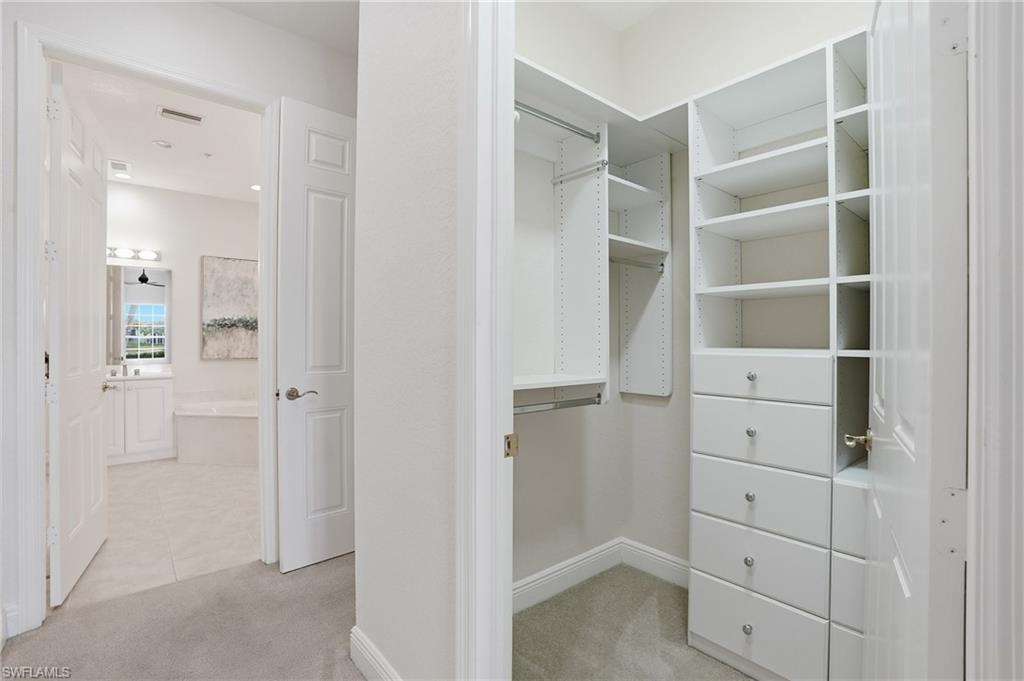 9263 Museo Circle, Unit 103 Naples, FL 34114 - Photo 22 of 49 Walk in closet with light colored carpet
