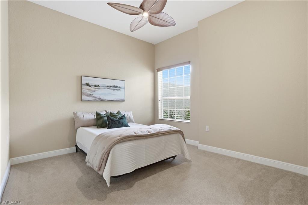9263 Museo Circle, Unit 103 Naples, FL 34114 - Photo 23 of 49 Bedroom featuring light carpet and a ceiling fan