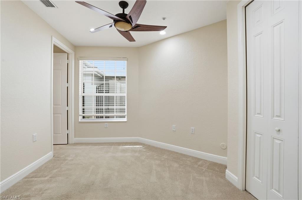 9263 Museo Circle, Unit 103 Naples, FL 34114 - Photo 26 of 49 Bedroom 3 with light carpet and a ceiling fan