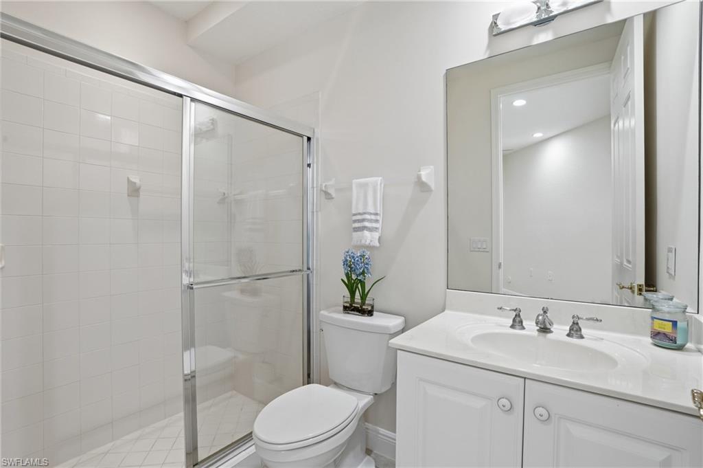 9263 Museo Circle, Unit 103 Naples, FL 34114 - Photo 27 of 49 Bathroom 3 featuring vanity and a shower stall