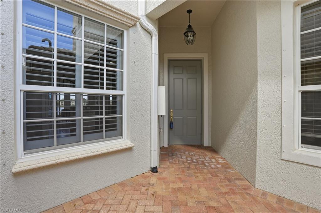 9263 Museo Circle, Unit 103 Naples, FL 34114 - Photo 29 of 49 Entrance to property with stucco siding